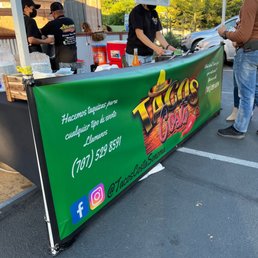 a man serving food at a stand a man serving food at a stand