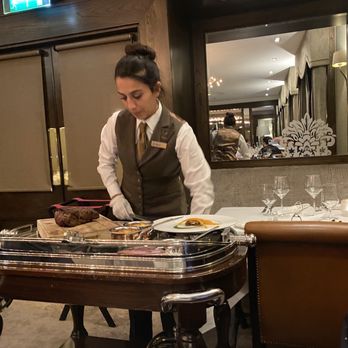 The Saddle Room Restaurant - Server presenting the dish and slicing for the table - Diners Near Me - Dublin, D The Saddle Room Restaurant - Server presenting the dish and slicing for the table - Diners Near Me - Dublin, D