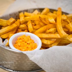 Mamma Khouri's - French Fries ·
Fried Fresh-Cut Potatoes, Seasoned with Paprika, Salt,
Garlic, and Black Pepper Mix, with Toom Ketchup Dip