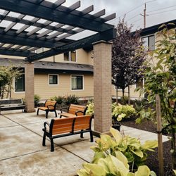 Stephanie Gardens Residential - Courtyard featuring gardens, patio and benches