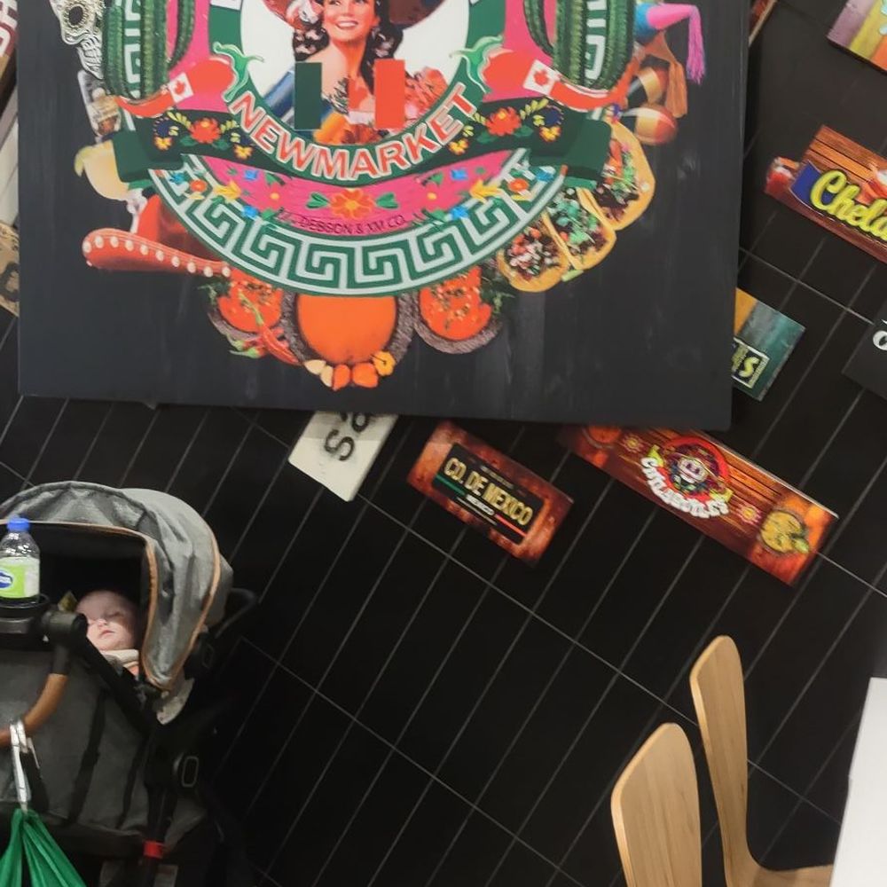 La Mexicanada - a woman sitting at a table in a restaurant - Mexican Near Me - Newmarket, Ontario La Mexicanada - a woman sitting at a table in a restaurant - Mexican Near Me - Newmarket, Ontario