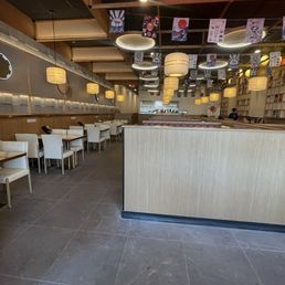 Dining area : left side regular tables and right side booths for conveyor belt.