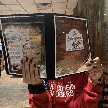 La Hacienda - a woman reading a menu - Mexican Near Me - Madison, Wisconsin La Hacienda - a woman reading a menu - Mexican Near Me - Madison, Wisconsin