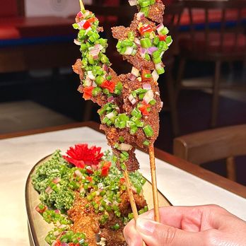 For U - a person holding a skewer of food - Dim Sum Near Me - New York, New York For U - a person holding a skewer of food - Dim Sum Near Me - New York, New York