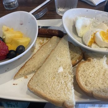 Another Broken Egg Cafe - This is the untouched plate I received - note the torn "un toast", meager fruit cup, hard yolk egg. Sausage #2 is hiding. - Breakfast & Brunch Near Me - Streetsboro, Ohio