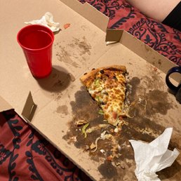a half eaten pizza in a box a half eaten pizza in a box