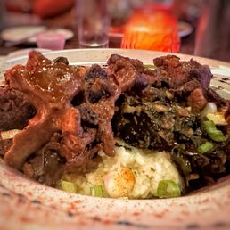 Oxtail over mashed potatoes and collard greens. Oxtail over mashed potatoes and collard greens.