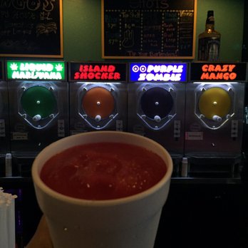 Mango's Daiquiris - a hand holding a cup of salsa - Bars Near Me - Baton Rouge, Louisiana