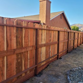 LM Landscaping - a wooden fence with a chimney - Landscaping Near Me