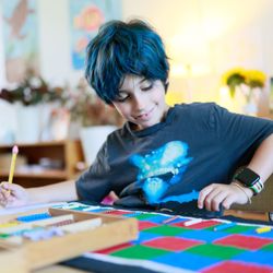 Fraser Woods Montessori School - Elementary student enjoys working with Montessroi math materials.