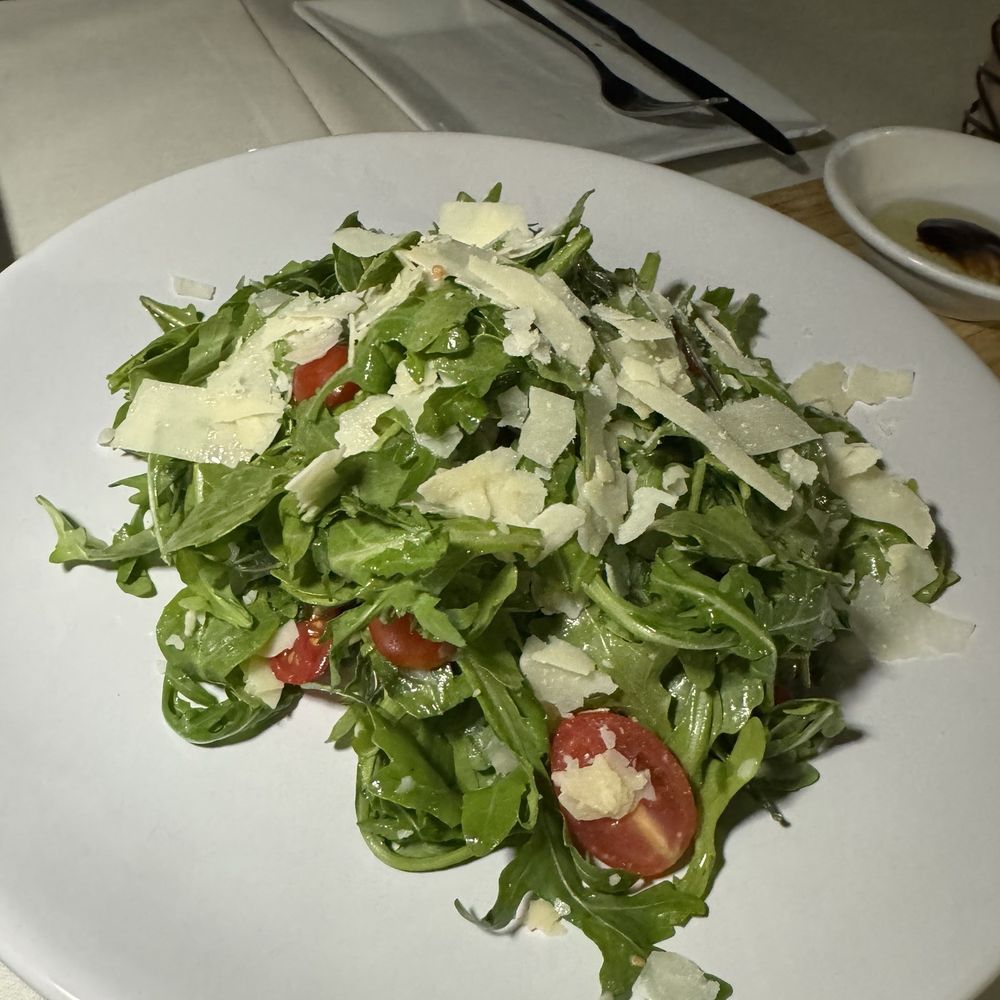 Arugula salad, cherry tomatoes, shaved Parmesan . Arugula salad, cherry tomatoes, shaved Parmesan .