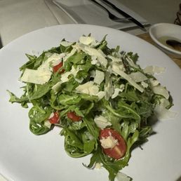 Arugula salad, cherry tomatoes, shaved Parmesan .