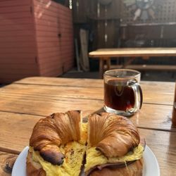 FairFix Cafe - Ham, egg, and cheese croissant with an Americano