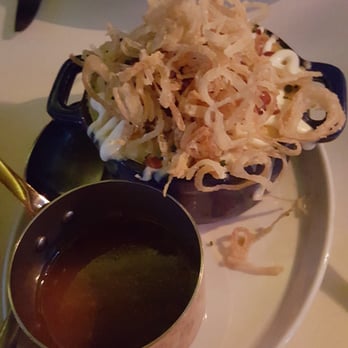 Maple & Ash - Baked loaded potato layered with short rib and topped with onion strings. - Steakhouses Near Me - Chicago, Illinois Maple & Ash - Baked loaded potato layered with short rib and topped with onion strings. - Steakhouses Near Me - Chicago, Illinois
