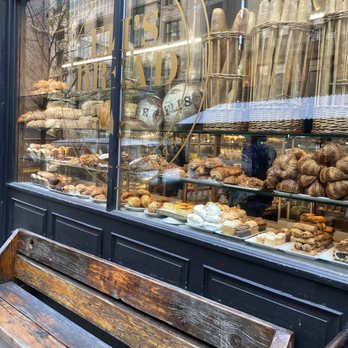 Eli's Essentials and Wine Bar - a bench in front of a bakery - Cafes Near Me - New York, New York