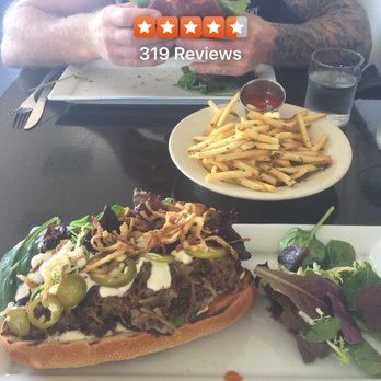 MRK  Public - Short rib sandwich, fries and fried chicken sandwich in my bf's hands lol - New American Near Me - San Clemente, California