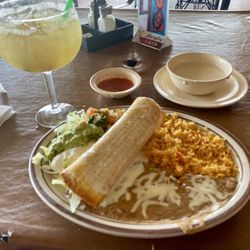 Senior Tequila - Lunch special of a spicy chicken chimichanga served with ensalada, guacamole, sour cream, refried beans & mexican rice.