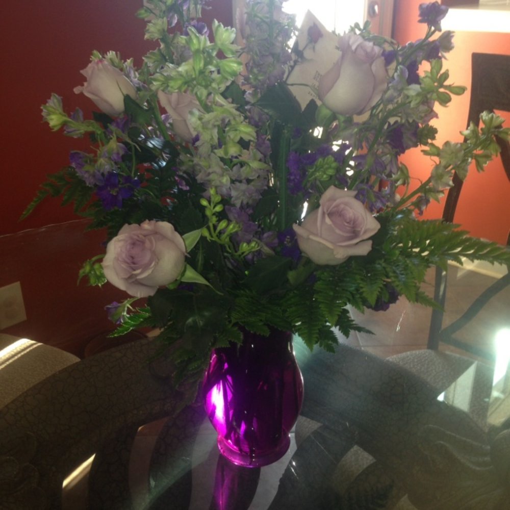 Purple roses in a pretty purple vase Purple roses in a pretty purple vase