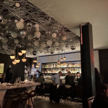Scarpetta - people sitting at tables in a restaurant - Italian Near Me - New York, New York Scarpetta - people sitting at tables in a restaurant - Italian Near Me - New York, New York