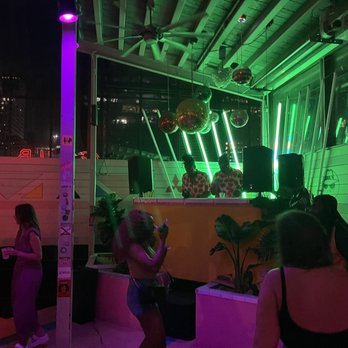 Coconut Club - a group of people standing in front of a bar - Bars Near Me - Austin, Texas Coconut Club - a group of people standing in front of a bar - Bars Near Me - Austin, Texas