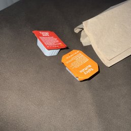 two packets of mcdonald's hamburgers on a couch
