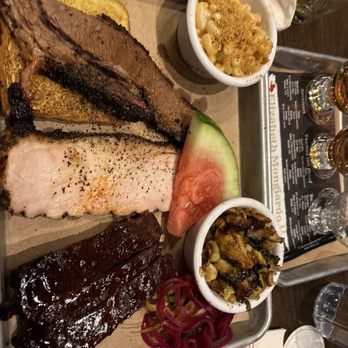 The Smoke Shop BBQ - Assembly Row - Main course of mixed meats Mac & cheese, Brussel sprouts, pickled onions a d watermelon - Barbeque Near Me - Somerville, Massachusetts The Smoke Shop BBQ - Assembly Row - Main course of mixed meats Mac & cheese, Brussel sprouts, pickled onions a d watermelon - Barbeque Near Me - Somerville, Massachusetts