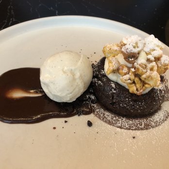 OLIVIA - Dessert special - flourless chocolate with cannoli cream and housemade chocolate sauce, vanilla bean sorbet, and caramel popcorn - Italian Near Me - Tampa, Florida OLIVIA - Dessert special - flourless chocolate with cannoli cream and housemade chocolate sauce, vanilla bean sorbet, and caramel popcorn - Italian Near Me - Tampa, Florida