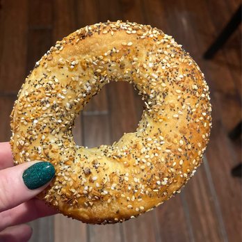 Bagel Cafe - a hand holding a bagel with sesame seeds - Bagels Near Me - Norristown, Pennsylvania Bagel Cafe - a hand holding a bagel with sesame seeds - Bagels Near Me - Norristown, Pennsylvania