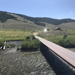 Woolley's Rendezvous at the Bridge Street Trailhead - Bar view looking at the cattle across the bridge