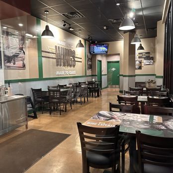 Wingstop - the inside of a restaurant with tables and chairs - Chicken Wings Near Me - Memphis, Tennessee Wingstop - the inside of a restaurant with tables and chairs - Chicken Wings Near Me - Memphis, Tennessee