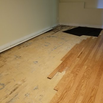 Eagle Hardwood Flooring - Back room before damaged floor was removed and new floor installed. - Flooring Near Me - Dorchester, Massachusetts