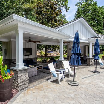 The Deck Tech - a patio with chairs and umbrellas - Decks & Railing Near Me - Moseley, Virginia