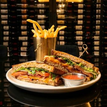 The Gibson - Monte Cristo Club- French toast-style sourdough bread, , powdered sugar, blackberry pepper mayo, sliced black forest ham, smoked turkey, bac - American Near Me - Dallas, Texas