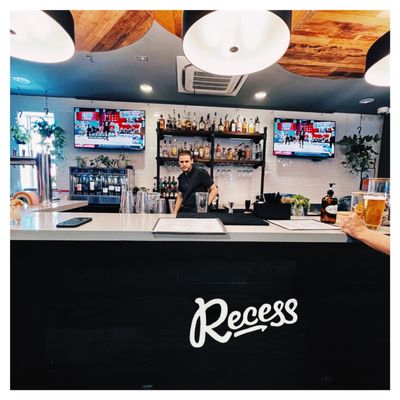 Photo of Recess - Santa Ana, CA, US. a man behind the bar at a restaurant