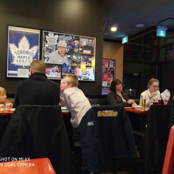 St. Louis Bar & Grill - people sitting at a table - Sports Bars Near Me - Cambridge, Ontario St. Louis Bar & Grill - people sitting at a table - Sports Bars Near Me - Cambridge, Ontario