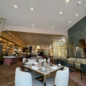 Astra - a dining area with a table and chairs - American Near Me - San Francisco, California Astra - a dining area with a table and chairs - American Near Me - San Francisco, California