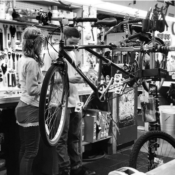 Trail Head Cyclery - Others pitching in to help Dave feed frayed cables through the shifter holes. - Bikes Near Me - Cupertino, California Trail Head Cyclery - Others pitching in to help Dave feed frayed cables through the shifter holes. - Bikes Near Me - Cupertino, California