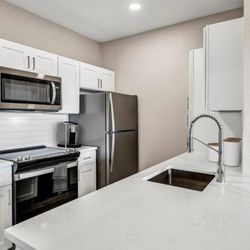 Stonelake at the Arboretum - Kitchen with Stainless Steel Appliances and Quartz Countertops