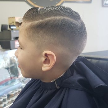 Low Skin Fade With A Long Blend Natural Part With A Trim Off The