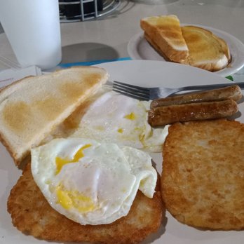 Minneola Grill - Traditional Breakfast eggs over easy sourdough toast link sausage Strawberry jam and Newspaper - Breakfast & Brunch Near Me - Minneola, Florida Minneola Grill - Traditional Breakfast eggs over easy sourdough toast link sausage Strawberry jam and Newspaper - Breakfast & Brunch Near Me - Minneola, Florida