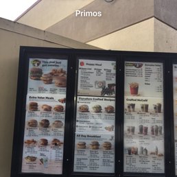 menus and prices on the outside of a restaurant