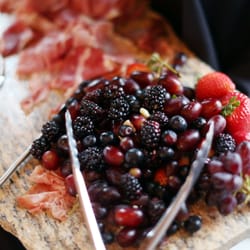 Cracked Pepper Catering & Bakery - Fresh Fruit, cheese, cured meats, breadsticks and bacon wrapped dates and brisket stuffed mushrooms for cocktail hour.