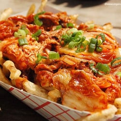 Try our very own Kimchi Fries! French fries served with caramelized kimchi, cheese wiz, and fresh-cut scallion.