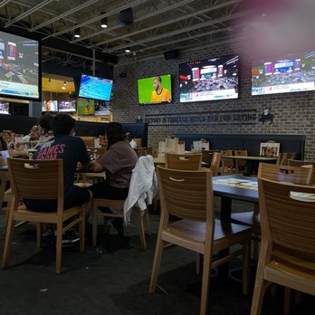 Buffalo Wild Wings - people sitting at tables in a sports restaurant - Chicken Wings Near Me - Pearland, Texas