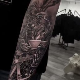 Alice In Wonderland. The crazy rabbit "Thackery" on top and the "Queen Of Hearts" on the bottom. (Outer forearm) Alice In Wonderland. The crazy rabbit "Thackery" on top and the "Queen Of Hearts" on the bottom. (Outer forearm)