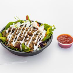 Shawarma Point - Combination of beef & lamb cooked and chopped to perfection. Served on a bed of basmati rice, spring mix & our signature white sauce.