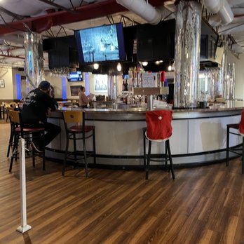 Canyon 66 Restaurant and Lounge - a bar with red chairs - Sports Bars Near Me - KINGMAN, Arizona