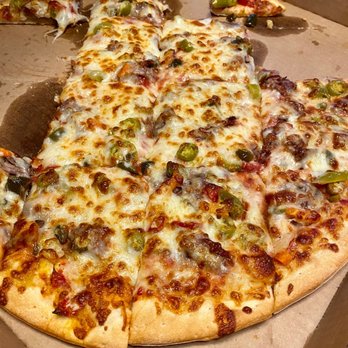 Sizzaly Pizza - Family attacking the Italian Pizza already - Pizza Near Me - Naperville, Illinois