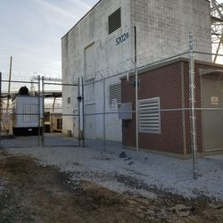 Reliable Fence - 10ft Galvanized Chain Link with Top Rail, Middle Rail, Barbed Wire & Razor Ribbon in Bethesda, MD for Longwood Construction.