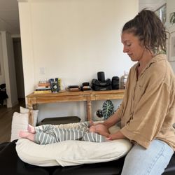 The Vitalist Collective - Photo in the community adjusting bay: Dr. Corey with her magic touch adjusting my little one